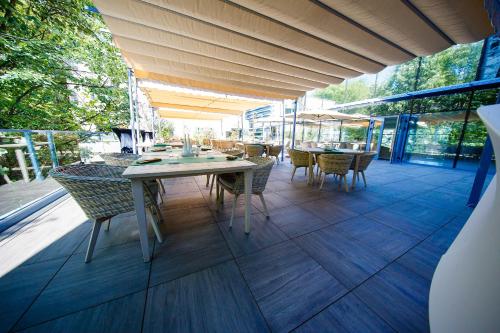 an outdoor patio with a table and chairs at Pleiada Boutique Hotel & Spa in Iaşi