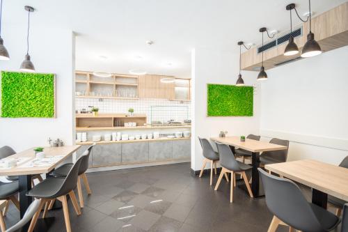 a dining room with wooden tables and chairs at Hotel Orion in Budapest