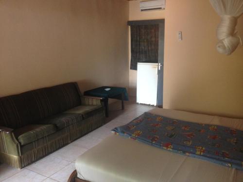 a living room with a couch and a table at Leybato Beach Hotel in Fajara