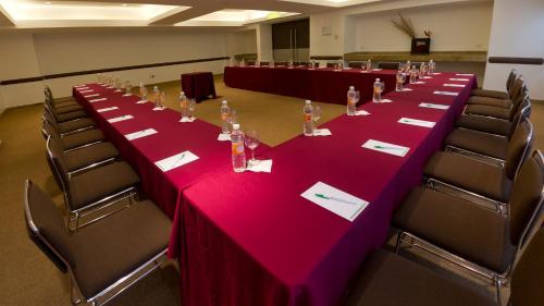a long table in a room with red table cloth at Holiday Inn Mexico City-Plaza Universidad by IHG in Mexico City