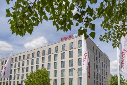 a large white building with signs on it at IntercityHotel Saarbrücken in Saarbrücken
