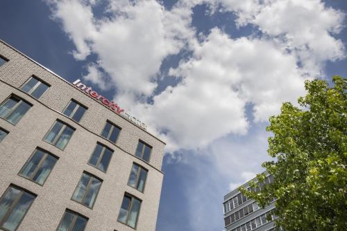a building with a sign on the top of it at IntercityHotel Saarbrücken in Saarbrücken