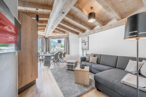 a living room with a couch and a table at AlpenParks Chalet & Apartment Alpina Seefeld in Seefeld in Tirol