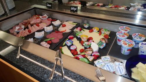 a buffet line with many different types of food at Hotel Neue Stuben in Wolfsburg