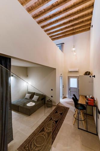 a bedroom with a bed and a desk in a room at Lindos Calmare Suites in Líndos