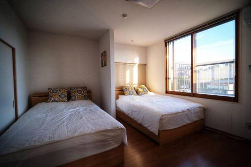 Llit o llits en una habitació de 太宰苑 - Dazaien Traditional Japanese houses