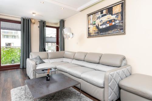 a living room with a couch and a table at Apartments Gdańsk Drzewieckiego by Renters in Gdańsk