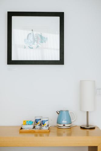 a picture frame on top of a wooden shelf at Boticas Hotel Art & SPA in Boticas