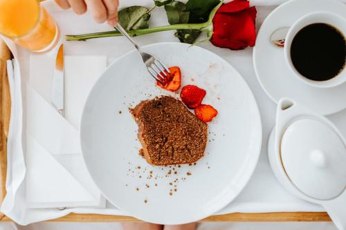 a piece of chocolate cake on a plate with strawberries at Boticas Hotel Art & SPA in Boticas