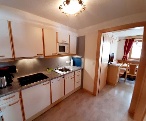 a kitchen with a sink and a counter top at Haus Achenrainer in Fiss