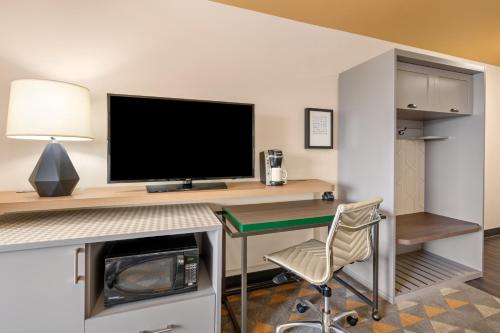 a computer desk with a monitor and a chair at Holiday Inn Yakima by IHG in Yakima