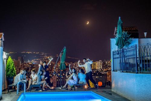 a group of people standing on the rooftop of a building at TM Apart Hotel in Tbilisi City
