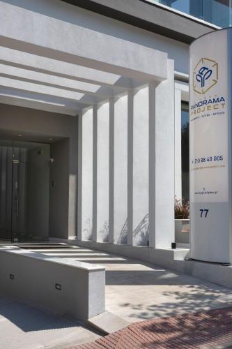 a white building with a sign in front of it at Athens Panorama Project in Athens