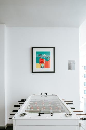 a large white table with a picture on a wall at Boticas Hotel Art & SPA in Boticas