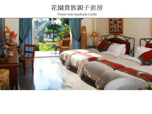 a hotel room with three beds and a table and chairs at Swan Lake Villa Resort in Nanwan