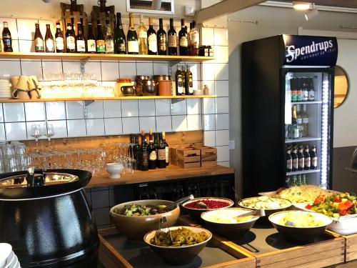 a buffet with bowls of food and bottles of wine at Tärnaby Sporthotell in Tärnaby
