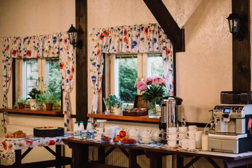 a kitchen with a table with food on it at Gościniec nad Wkrą in Błędowo