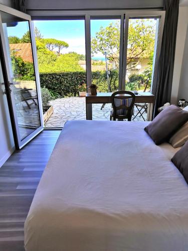 a bedroom with a large white bed and a table at Les Digues Vauban in Ciboure