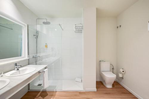 a white bathroom with a sink and a toilet at Sol Marbella Estepona Atalaya Park in Estepona