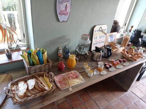 a table with various food items on it at Quinta Pereiro Tropic Garden, Algarve in Moncarapacho