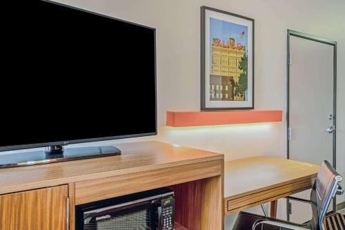 a flat screen tv sitting on top of a desk at La Quinta by Wyndham Waco Baylor Downtown in Waco