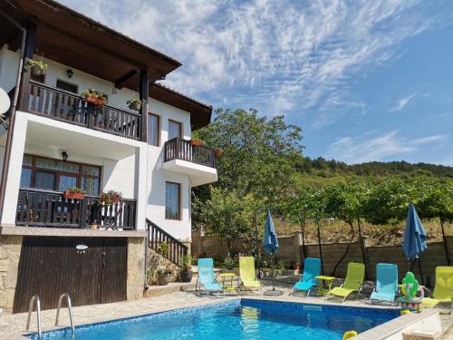 a villa with a swimming pool and a house at Villa Holly in Balchik