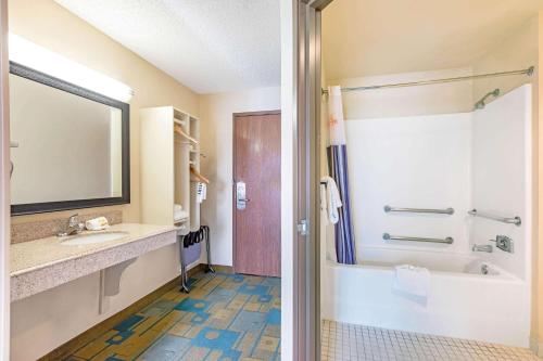 a bathroom with a tub and a sink and a shower at La Quinta by Wyndham El Paso East in El Paso