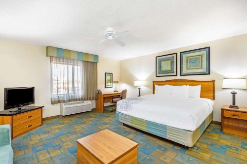 a hotel room with a bed and a flat screen tv at La Quinta by Wyndham El Paso East in El Paso