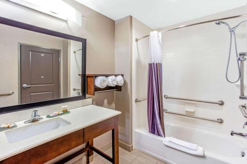 a bathroom with a tub and a sink and a shower at La Quinta by Wyndham Gonzales TX in Gonzales