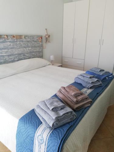 a bedroom with two beds with towels on the bed at Le Torrette di Anna - Tropea in Briatico