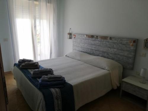 a bedroom with a bed with two towels on it at Le Torrette di Anna - Tropea in Briatico