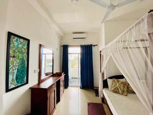 a bedroom with a bunk bed and a mirror at Bliss Apartment Hikkaduwa in Hikkaduwa