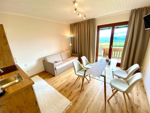 a living room with a couch and chairs and a table at Pleschinhof in Velden am Wörthersee