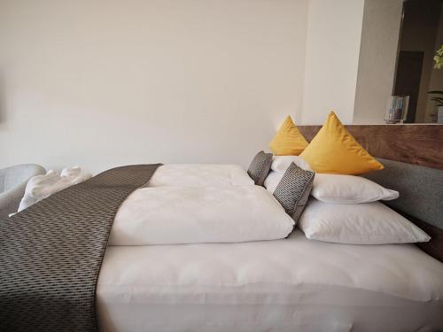 a large white bed with pillows on top of it at SEE Moment Appartements ADULTS ONLY in St. Wolfgang