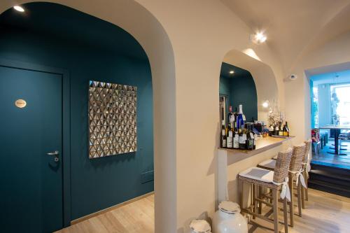 a wine tasting room with a blue door and a bar at Blu Hotel in Lavagna