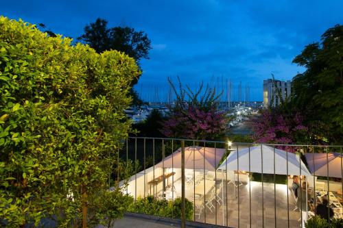 a view of a building through a fence at night at Blu Hotel in Lavagna