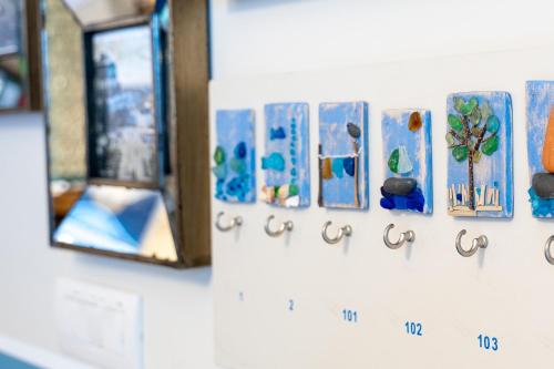 a wall with a row of paintings on a wall at Blu Hotel in Lavagna