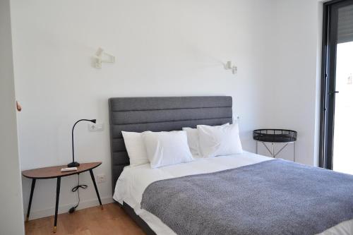 a bedroom with a large bed and a table at HOTEL S - ALOJAMENTO LOCAL in Castro Verde