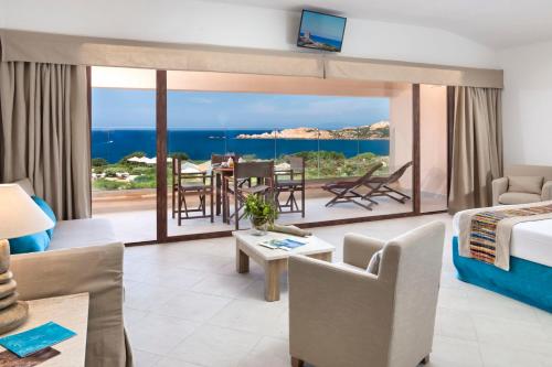 a living room with a view of the ocean at Hotel Relax Torreruja Thalasso & Spa in Isola Rossa