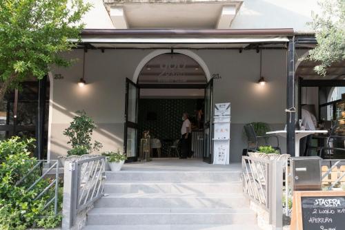 a store front with stairs leading into a building at ALBERGO 900Strati in Bergamo