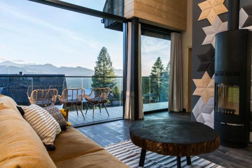 a living room with a couch and a table at udanypobyt OMG Houses in Kościelisko