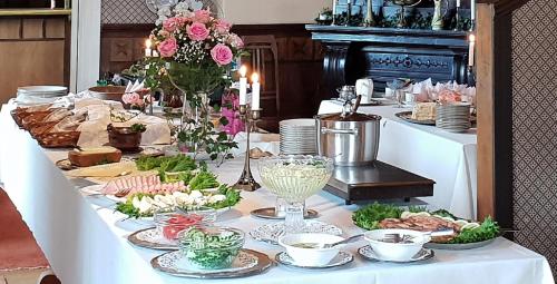 een lange tafel met borden met eten erop bij Urpolan Kartano Ky in Humppila