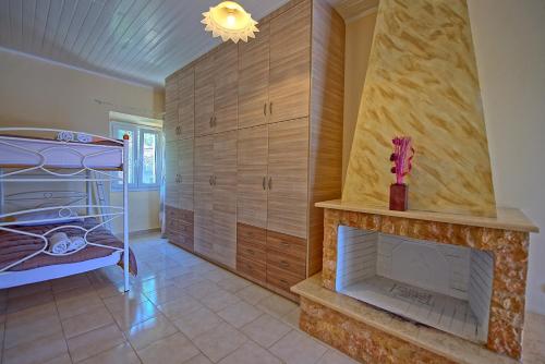 a living room with a fireplace and a bunk bed at Villa Giador by PosarelliVillas in Perítheia