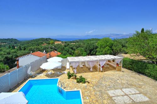 a villa with a swimming pool and a roof at Villa Giador by PosarelliVillas in Perítheia