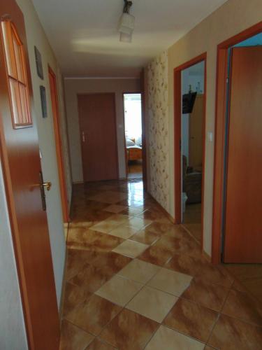a hallway of a house with a tile floor at Gospodarstwo Agroturystyczne Lucynka in Urszulin