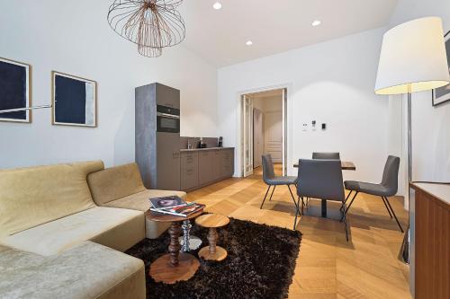 a living room with a couch and a table at Herzfeld Arthaus Vienna Premium Apartments in Vienna