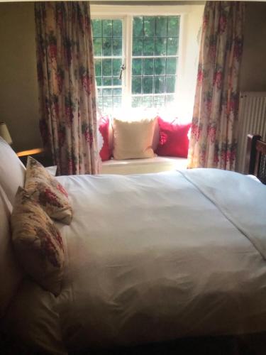 a bedroom with a large bed with a window at Horse & Hound Inn in Broadway
