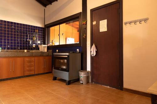 a kitchen with a sink and a stove in it at Estâncias da Serra dos Alves in Itabira