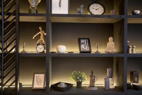 a shelf with clocks and other items on it at Quentin XL Potsdamer Platz in Berlin