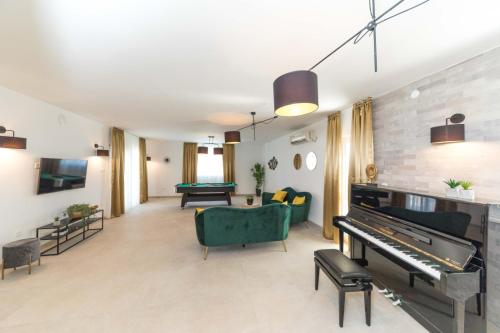 a living room with a piano and a couch at Villa Olivia Trogir in Trogir